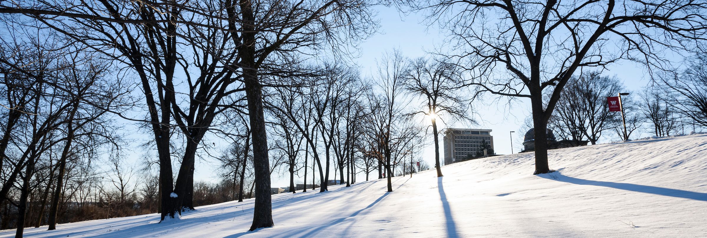 Van Hise Hall is visible behind a snow-covered Observatory Hill