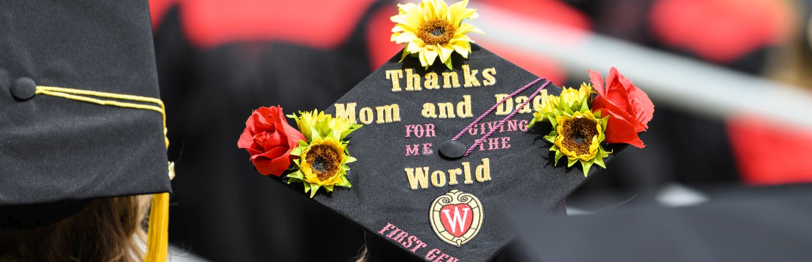 Graduation cap with the words "Thanks Mom and Dad for giving me the World (First Gen)"