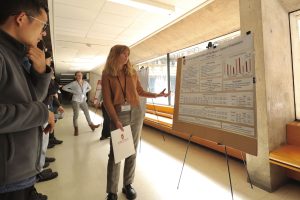 Undergraduate Linguistics major Eleanor Sand discussing her research in the poster session.