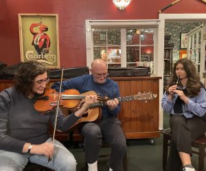 Karen Reshkin, Mike O'Regan, and Clíodhna Ní Chorráin sharing their musical talents with everyone during an evening session