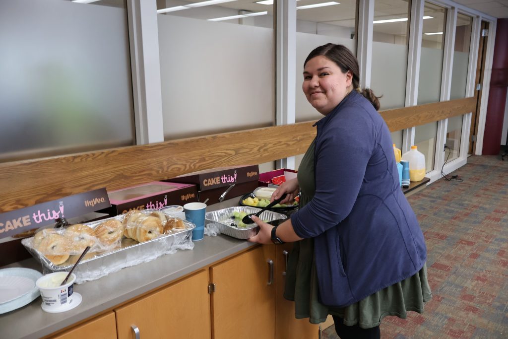 Linguistics PhD student Rachyl Hietpas organizing the refreshment table