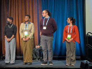 Undergraduate students Drane, Harb, and Rao receive an award at the LSA